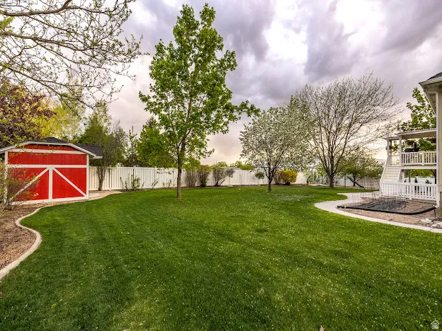 Fenced backyard with a storage shed