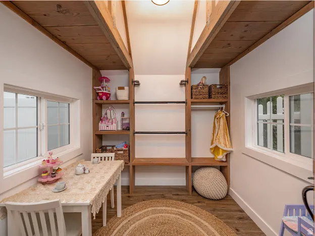 Recreation room with plenty of natural light, dark wood-style flooring, and wood ceiling