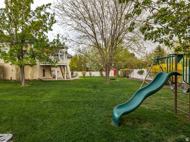 Fenced backyard with a patio and a storage unit