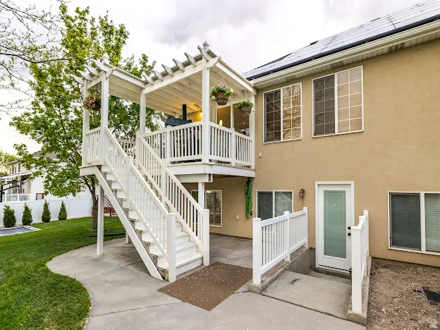 Exterior space with stairs and a wooden deck