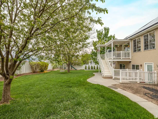 Fenced backyard with a patio area and a wooden deck