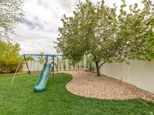 View of play area featuring a fenced backyard