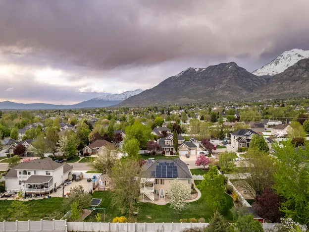 Aerial perspective of suburban area featuring a mountainous background