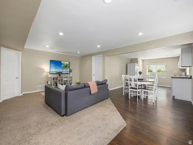 Living room featuring recessed lighting and dark wood-type flooring