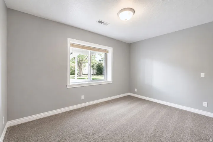 Room with neutral wall paint and light-toned carpet