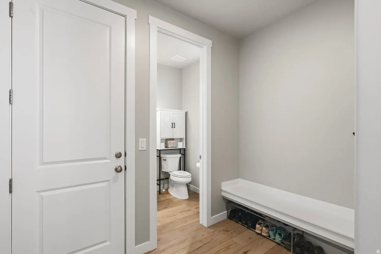 Mudroom featuring light wood-type flooring and baseboards