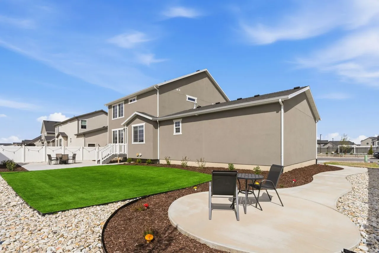 Rear view of property with a patio, a fenced backyard, stucco siding, outdoor dining area, and a residential view