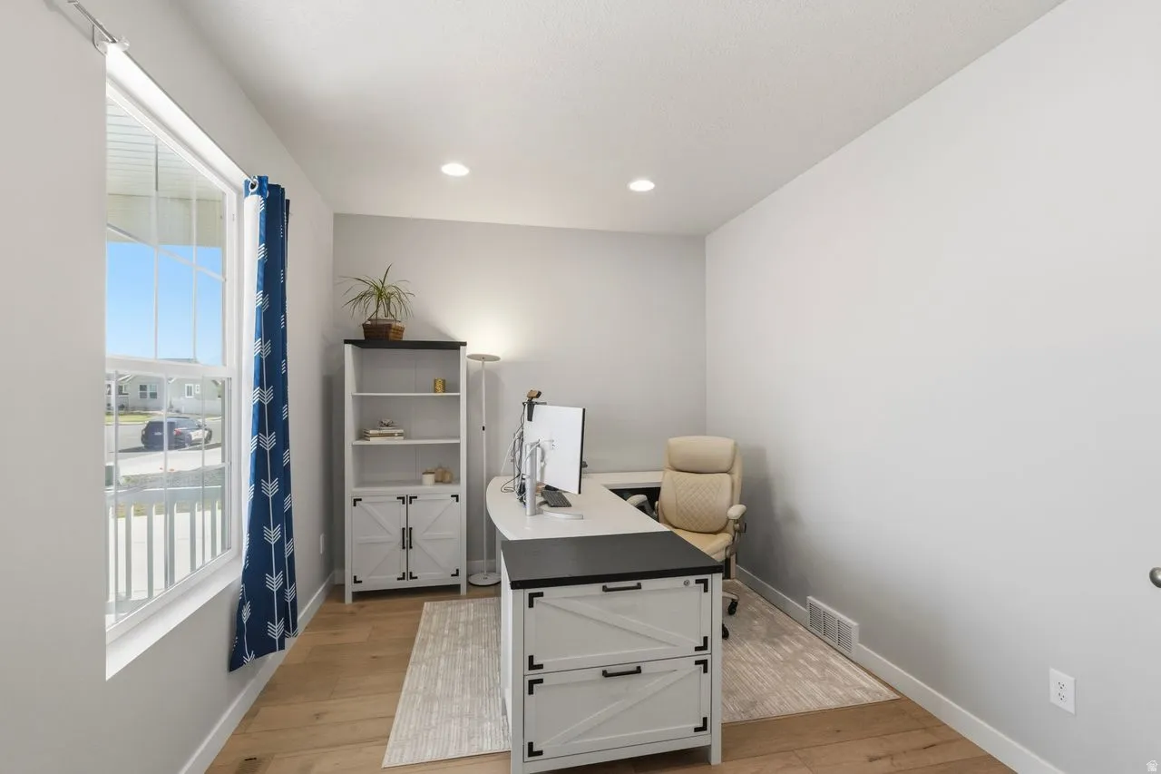 Office featuring light wood-style flooring and recessed lighting