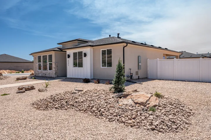 Contemporary stucco exterior with dark trim accents and white vertical siding