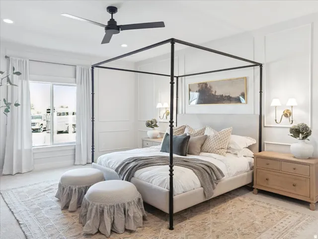 Recessed ceiling lighting, wall sconces, ceiling fan, and large windows provide ample illumination