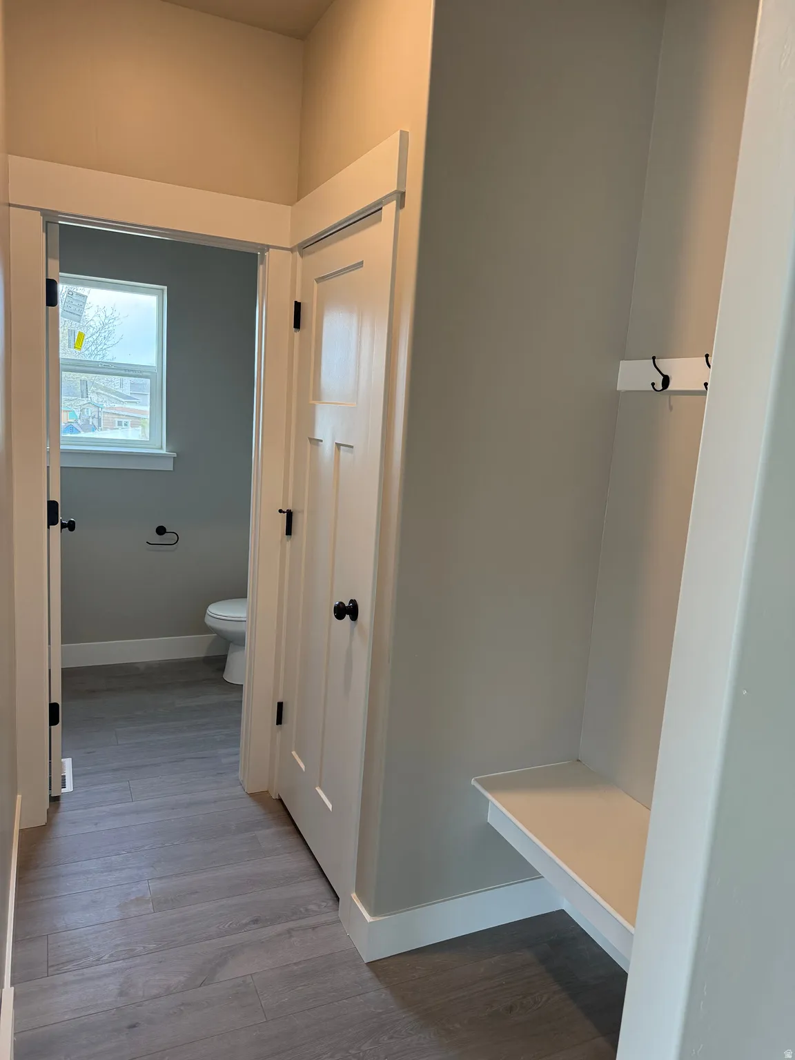 Bathroom with toilet and light wood-style floors