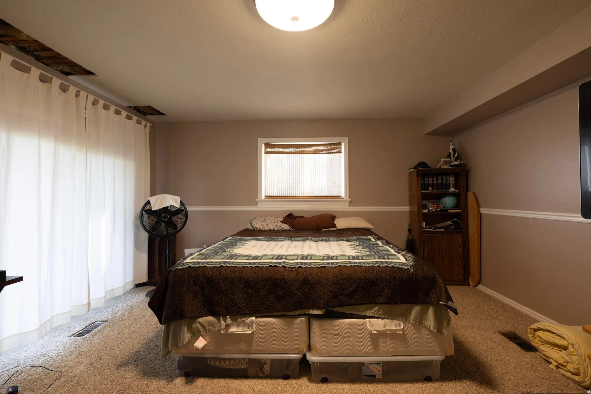 Bedroom featuring light carpet and baseboards
