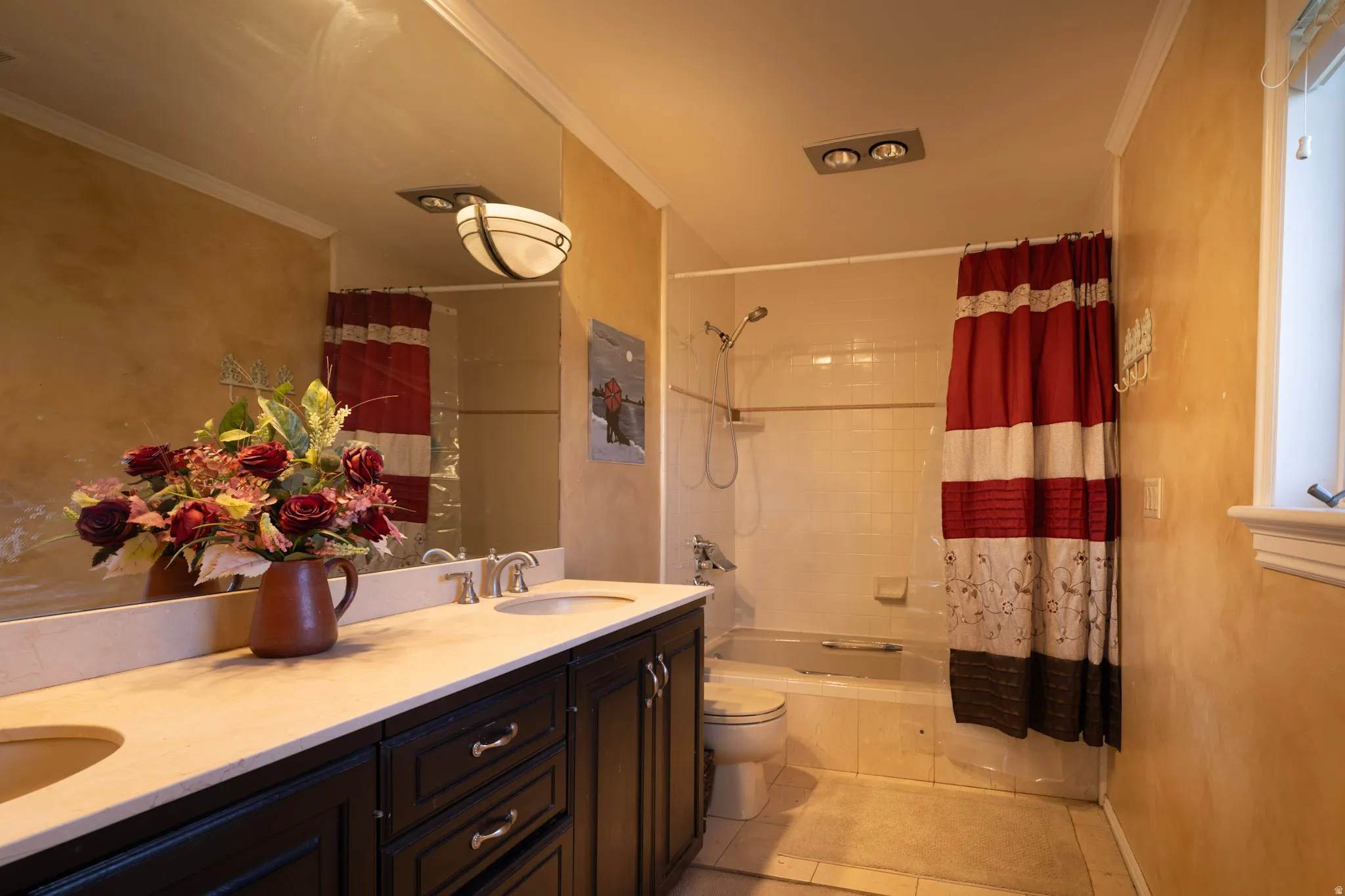 Bathroom with double vanity, ornamental molding, shower / tub combo with curtain, and light tile patterned floors