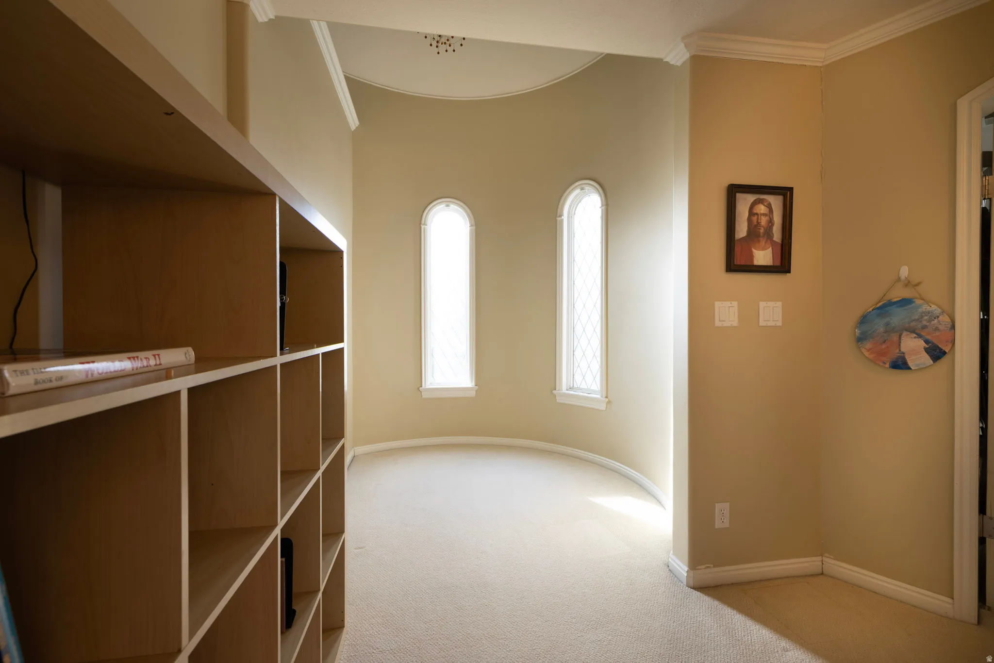 Hallway with light carpet and ornamental molding