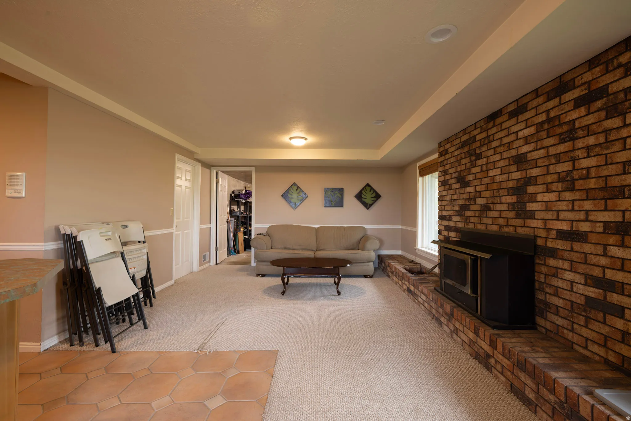 Living area with light carpet and baseboards
