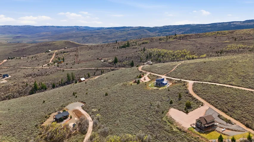 Aerial view of sparsely populated area featuring a mountain backdrop