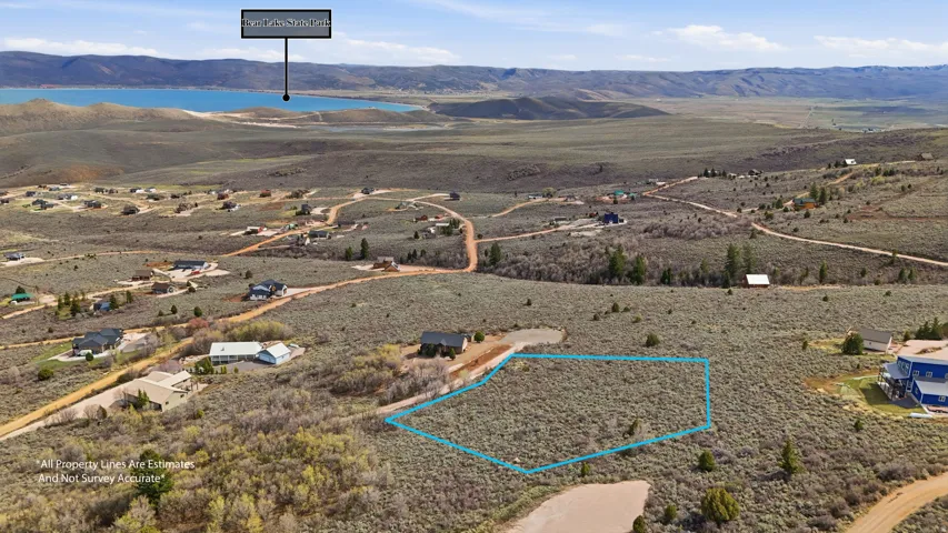 Aerial view of property's location featuring a mountain backdrop and property parcel outlined