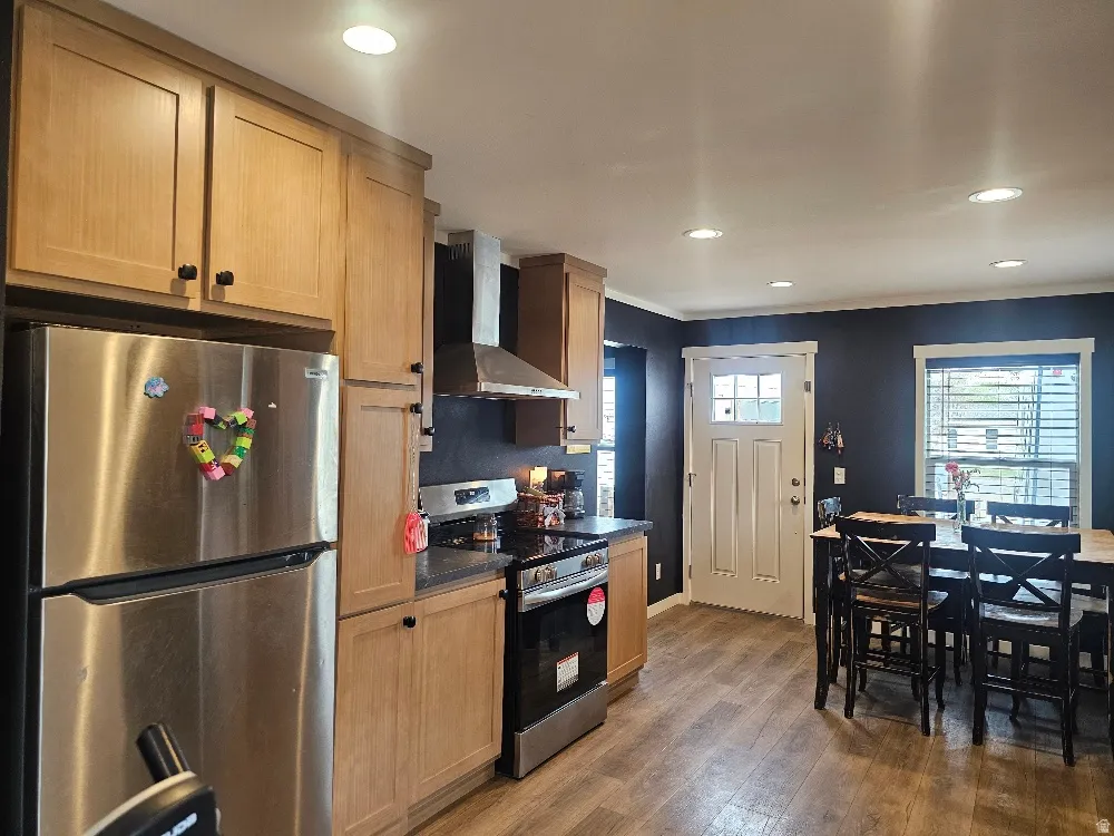 Kitchen with stainless steel appliances, dark wood finished floors, and recessed lighting