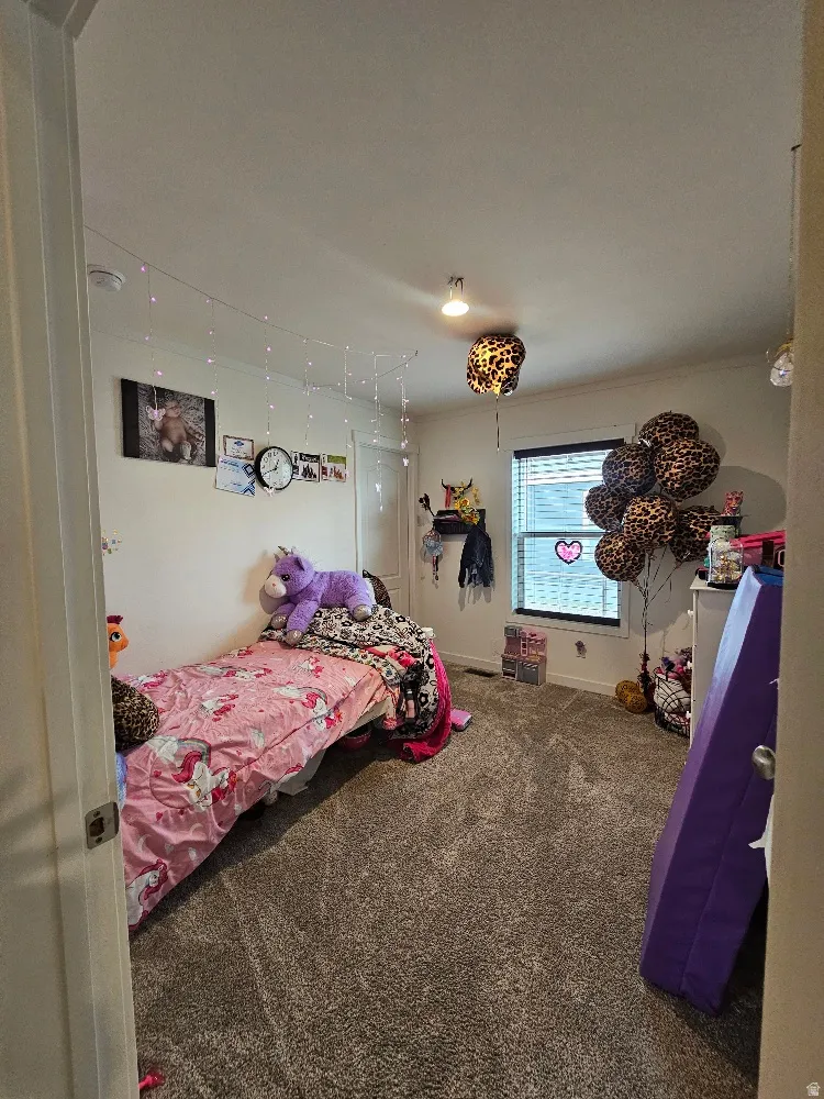 Carpeted bedroom featuring baseboards