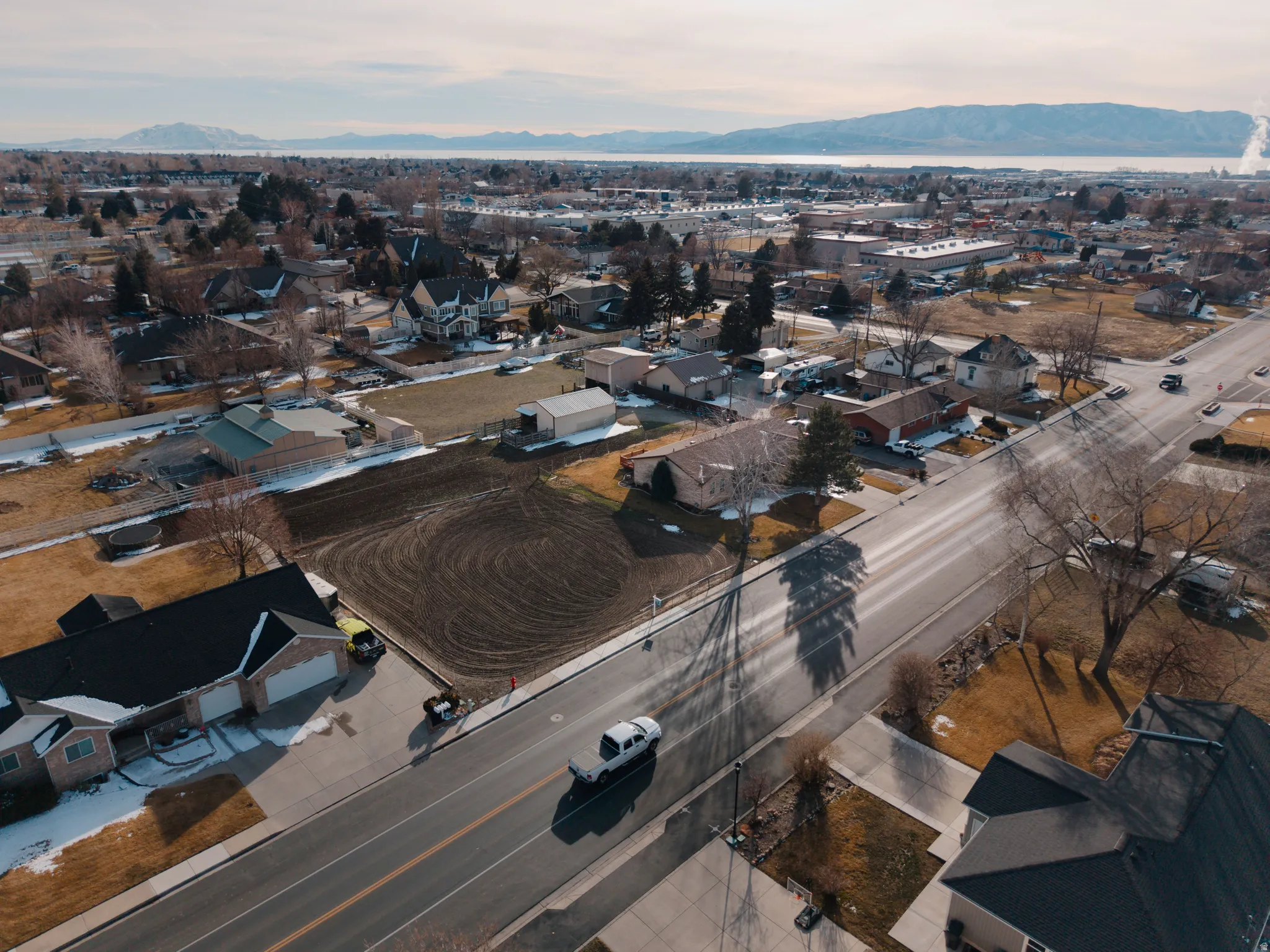 Aerial overview of property's location with nearby suburban area and a mountain backdrop