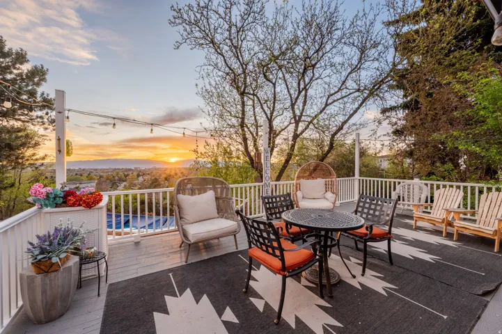 Deck at dusk with outdoor dining space and a patio