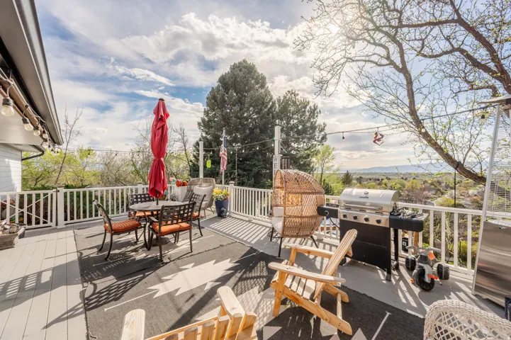 Wooden deck featuring grilling area and outdoor dining space