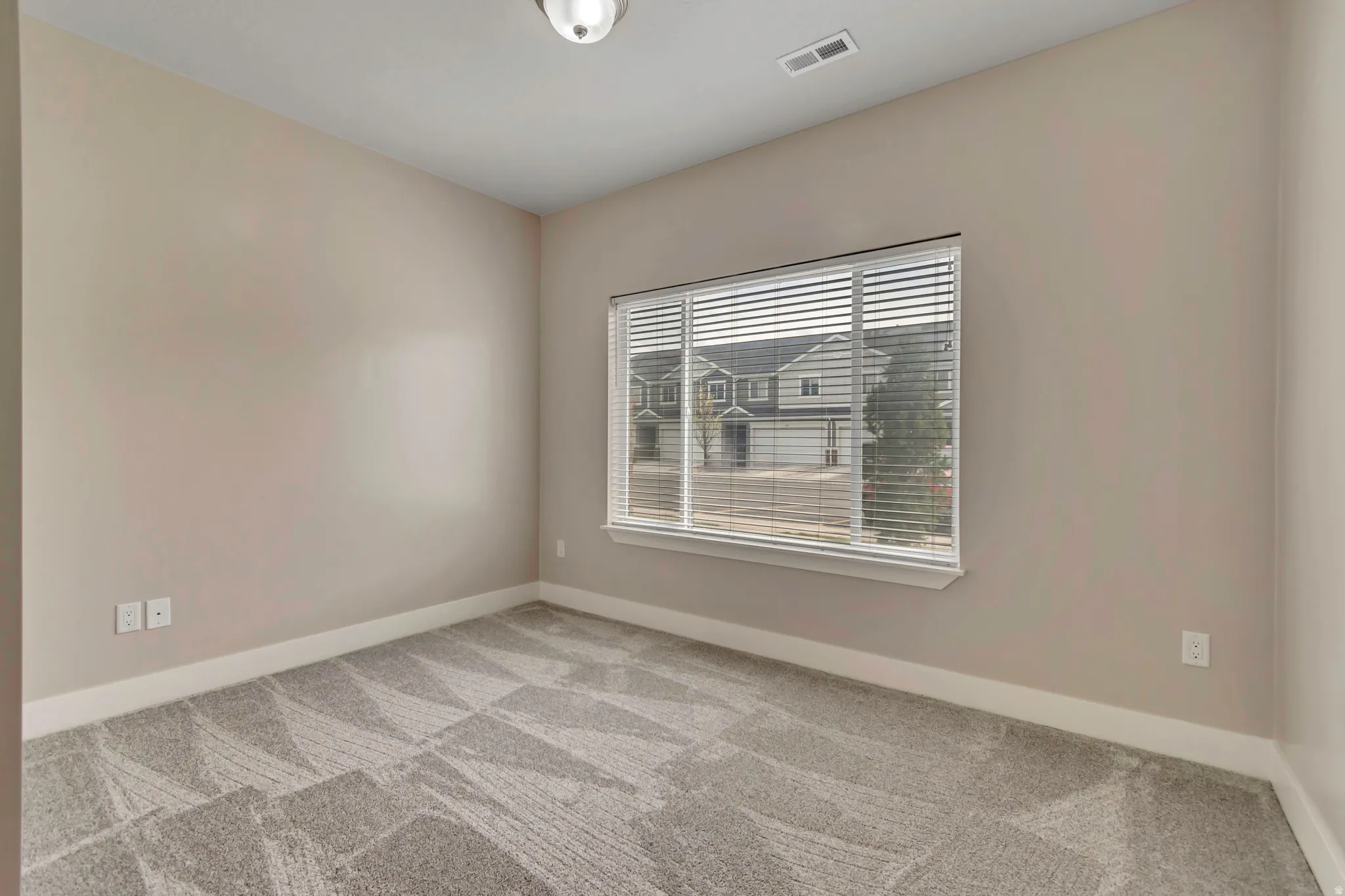 Main floor bedroom with brand new paint and carpet.
