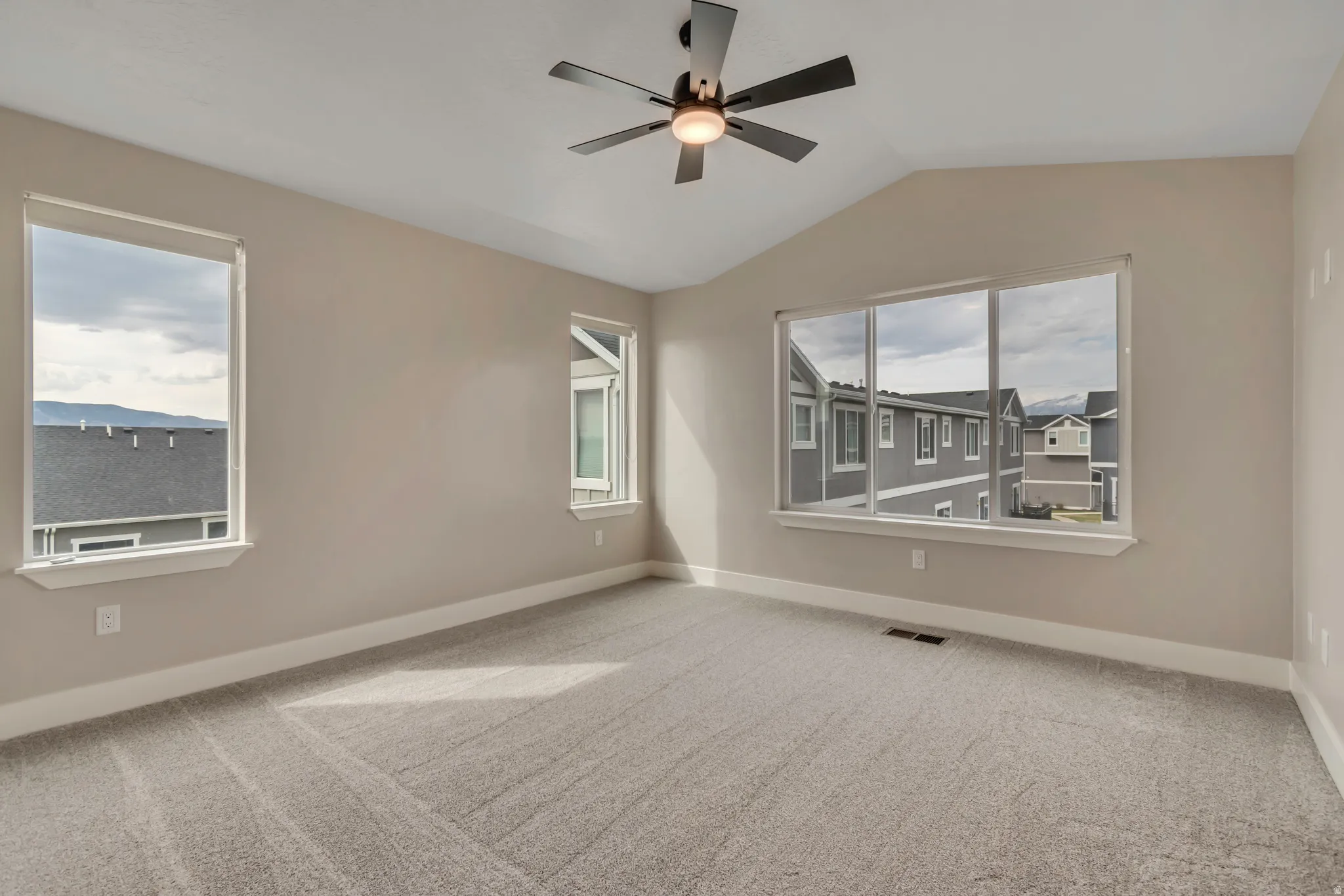 Spacious primary bedroom with new carpet and paint.