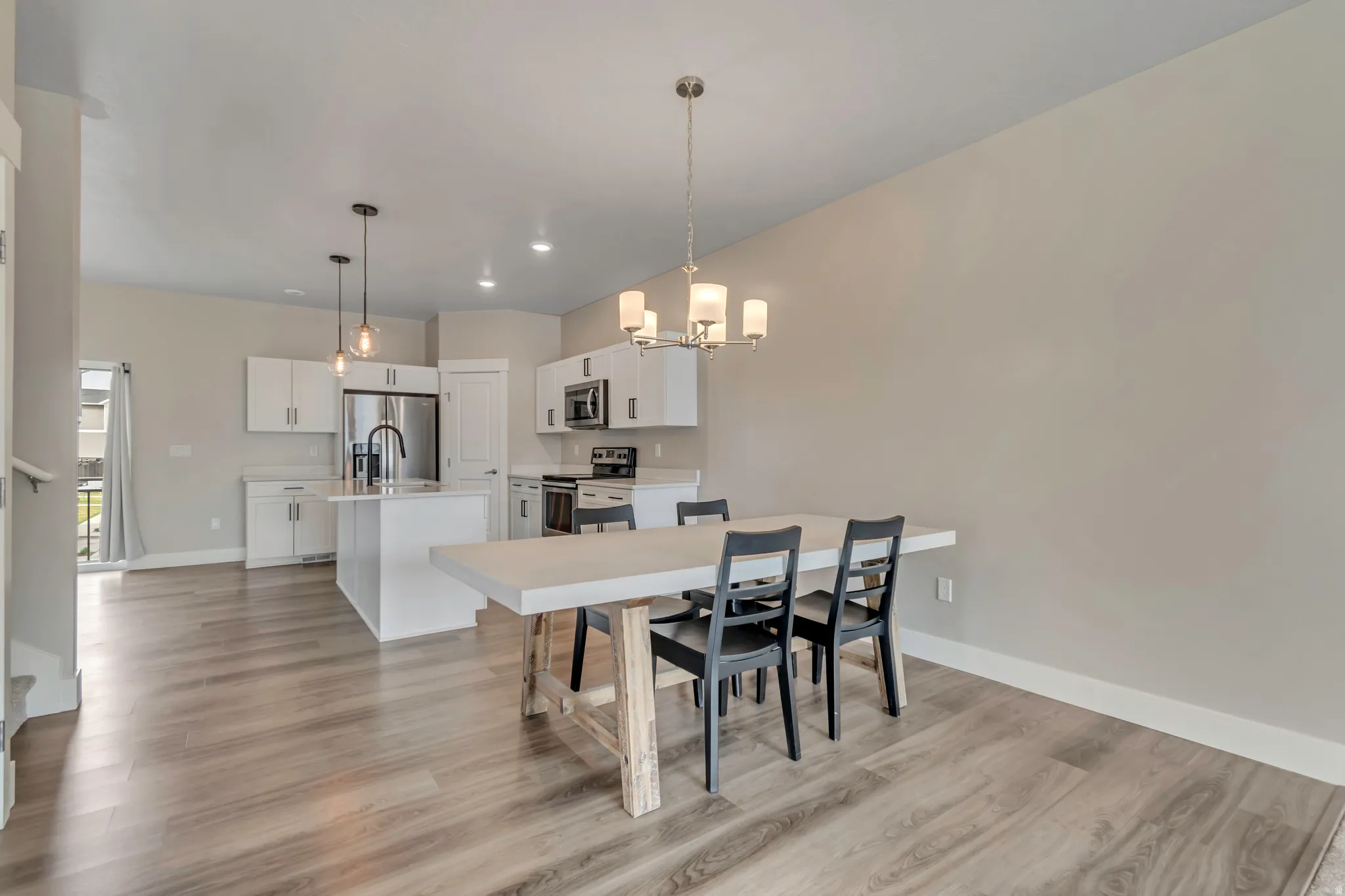Dining room with light wood LVP flooring.