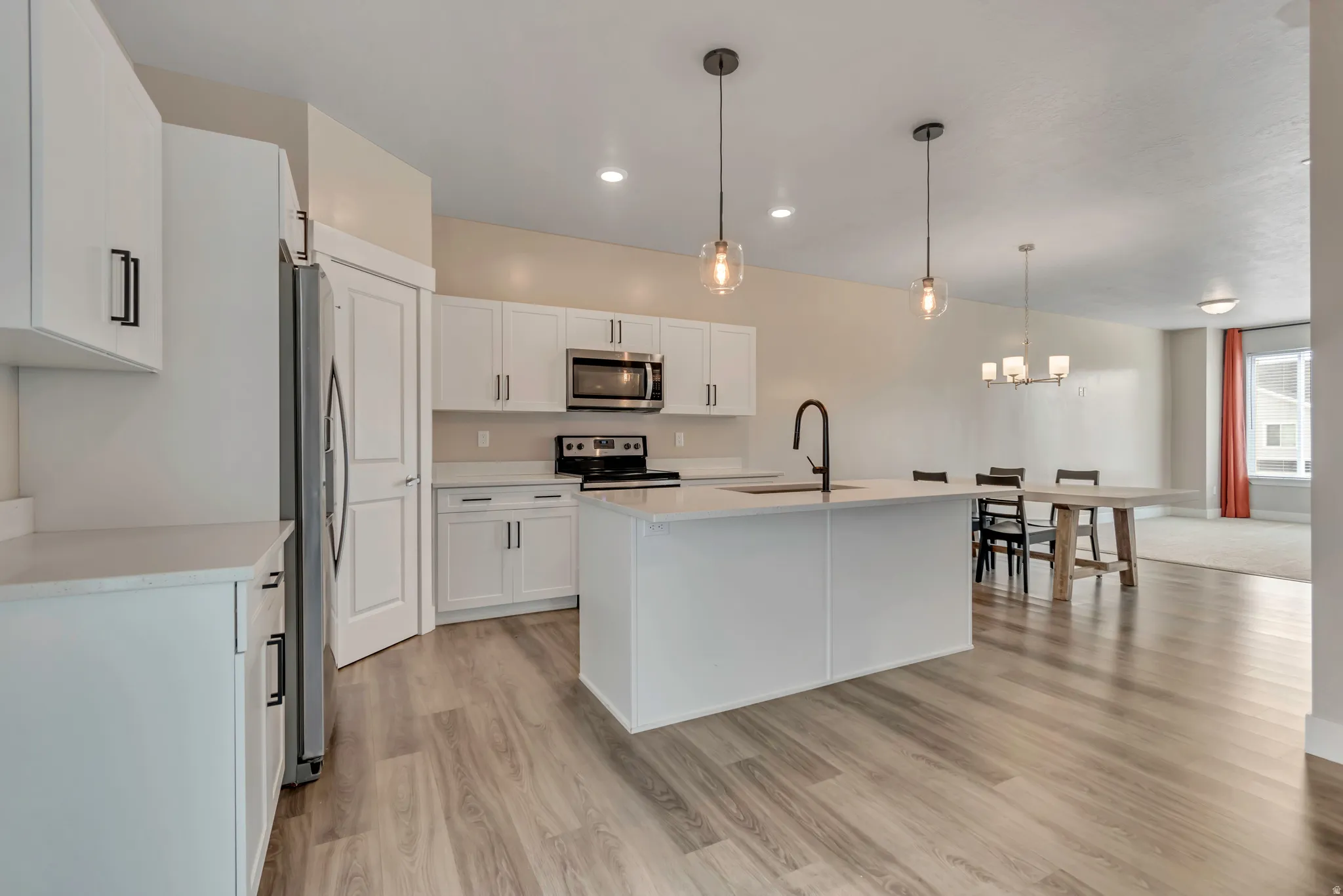 View from dining area into the kitchen and living room.