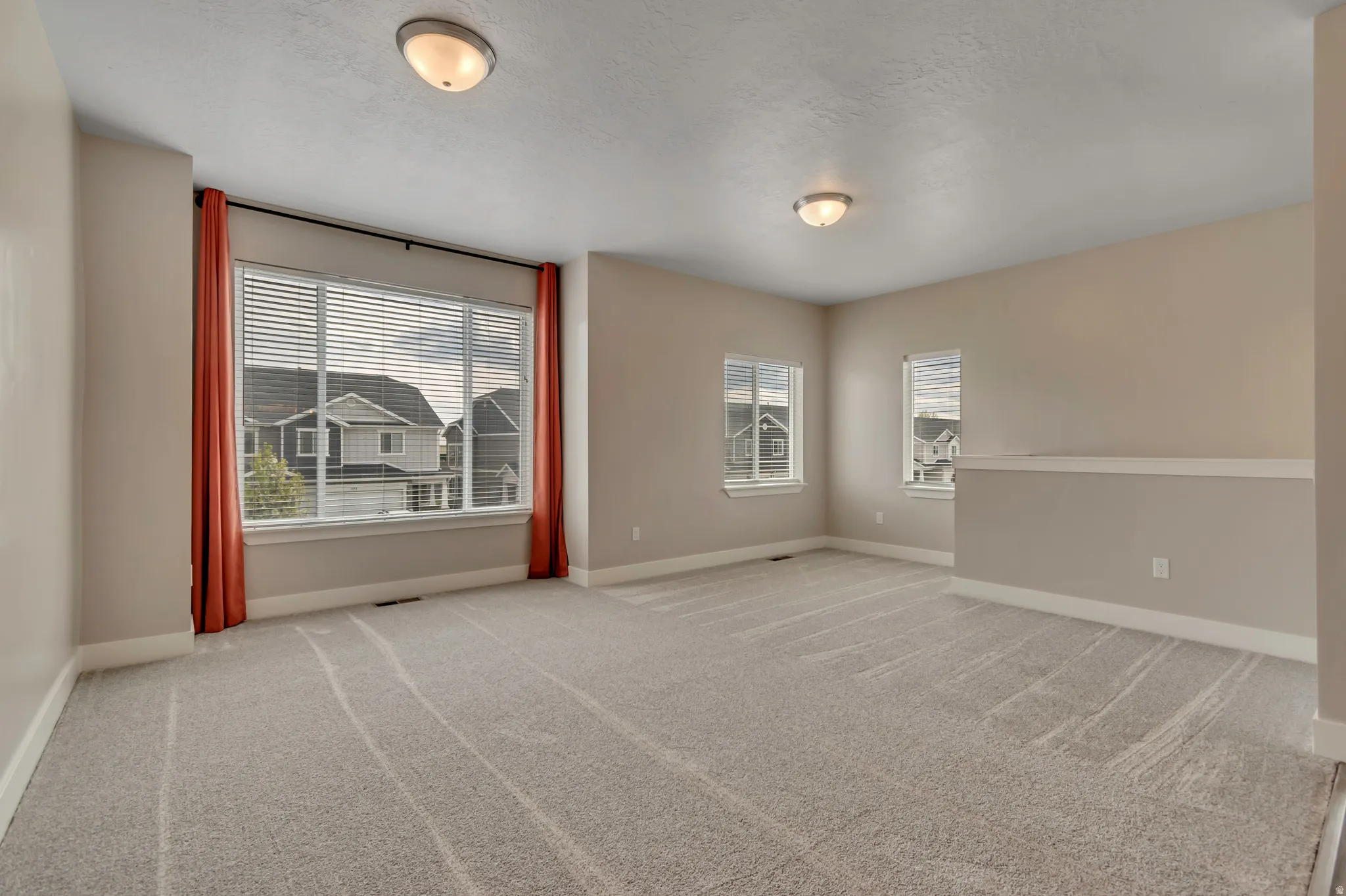 Living room with brand new carpet and paint.