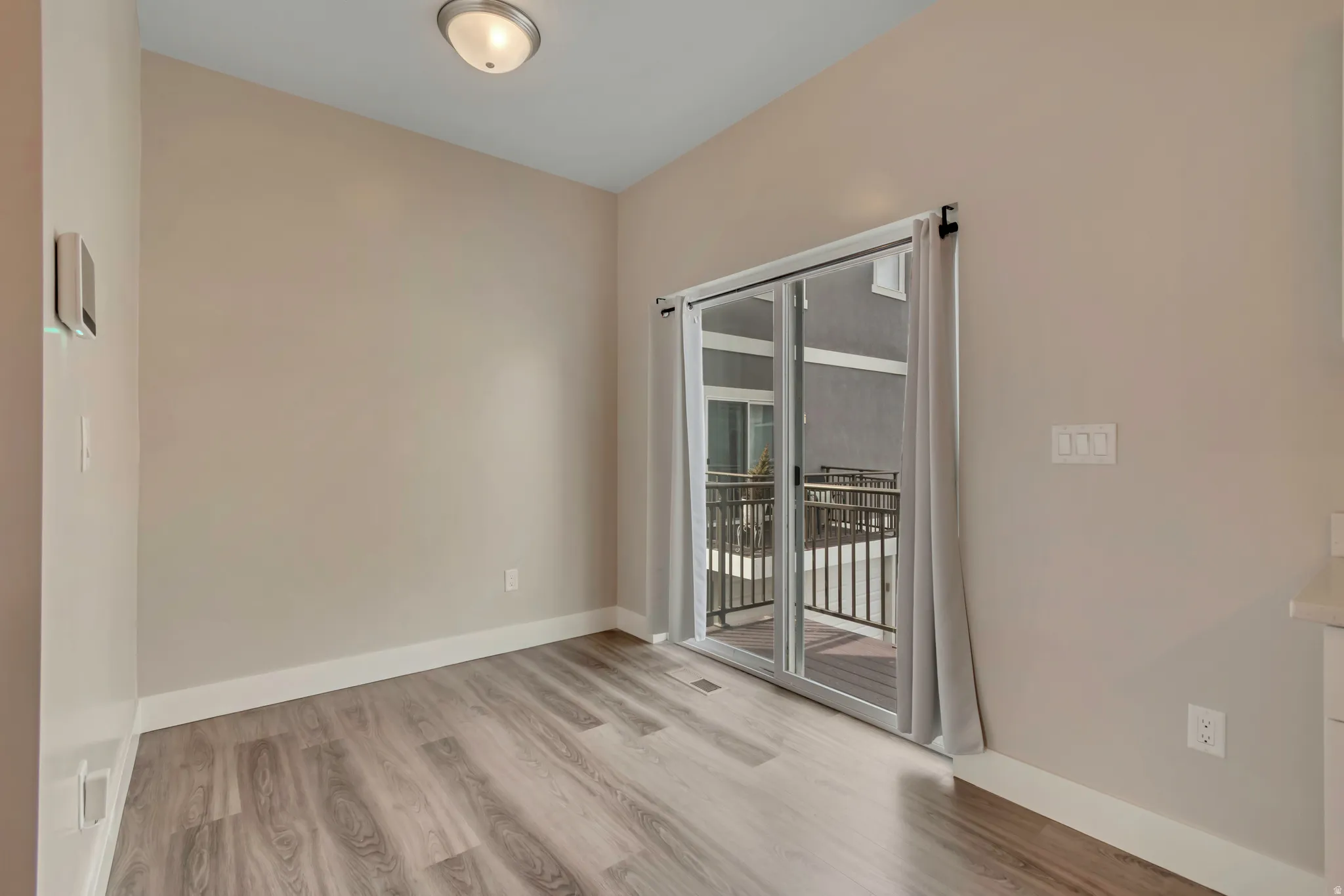 Dining area with sliding glass doors and balcony.