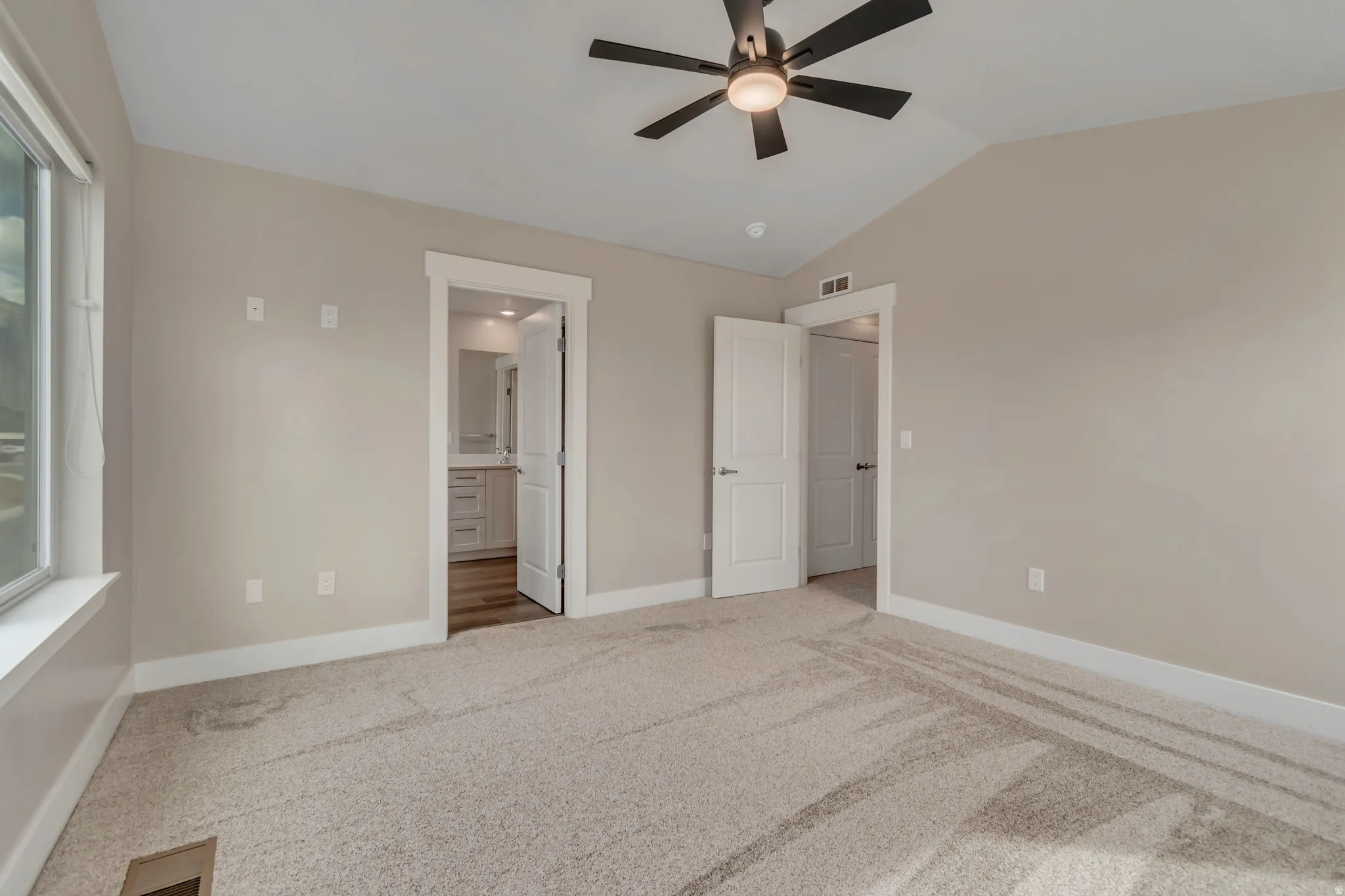 Spacious primary bedroom with walk-in closet and private bathroom.