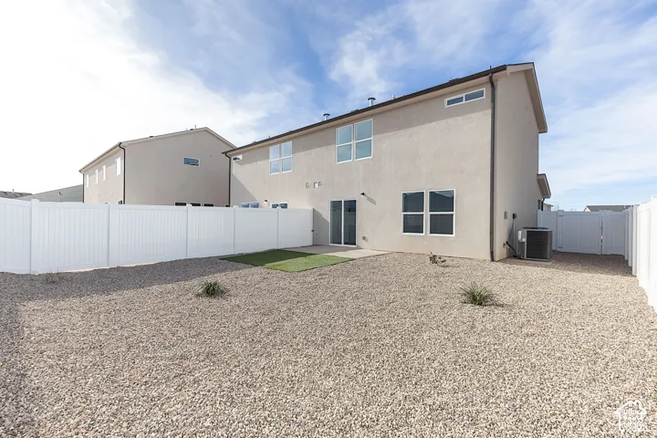 Back of property with a patio, a fenced backyard, and stucco siding