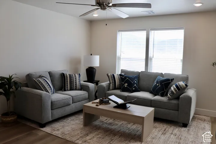 Living space featuring light-colored walls and wood-finish flooring