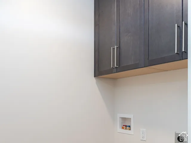 Laundry area featuring light wood-type flooring, cabinet space, electric dryer hookup, and hookup for a washing machine