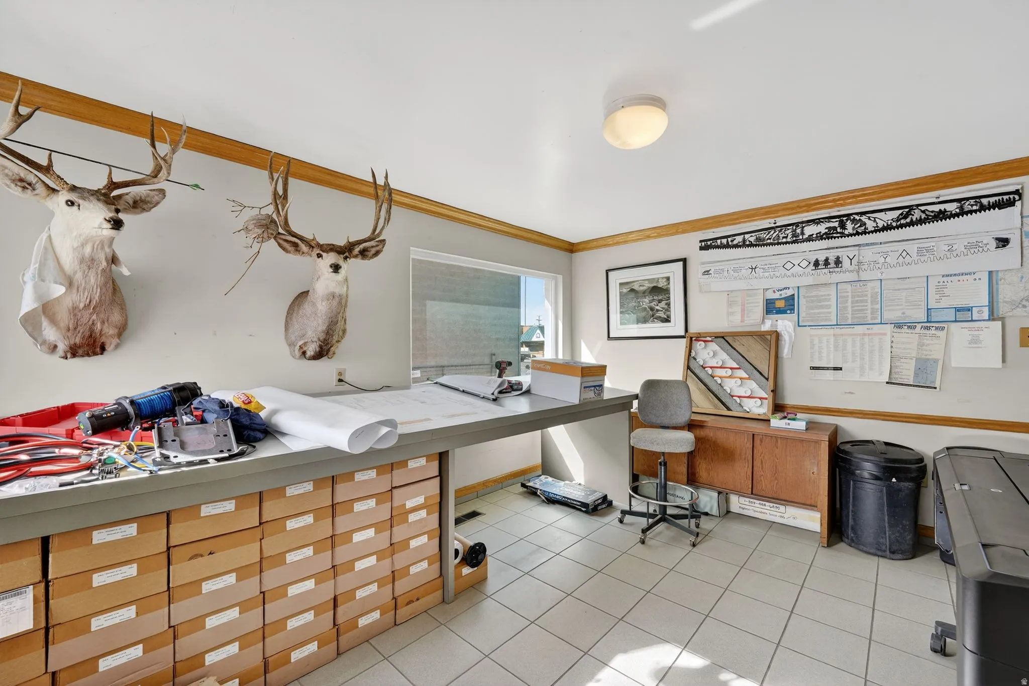 Office space with light tile patterned floors and crown molding