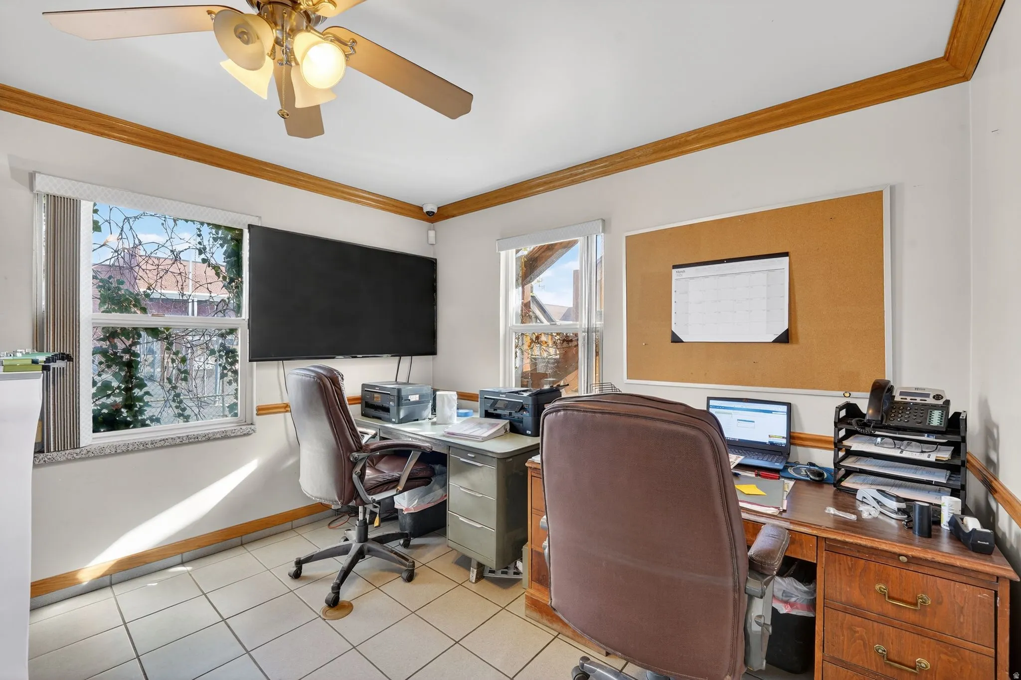 Office with ornamental molding, a ceiling fan, plenty of natural light, and light tile patterned floors