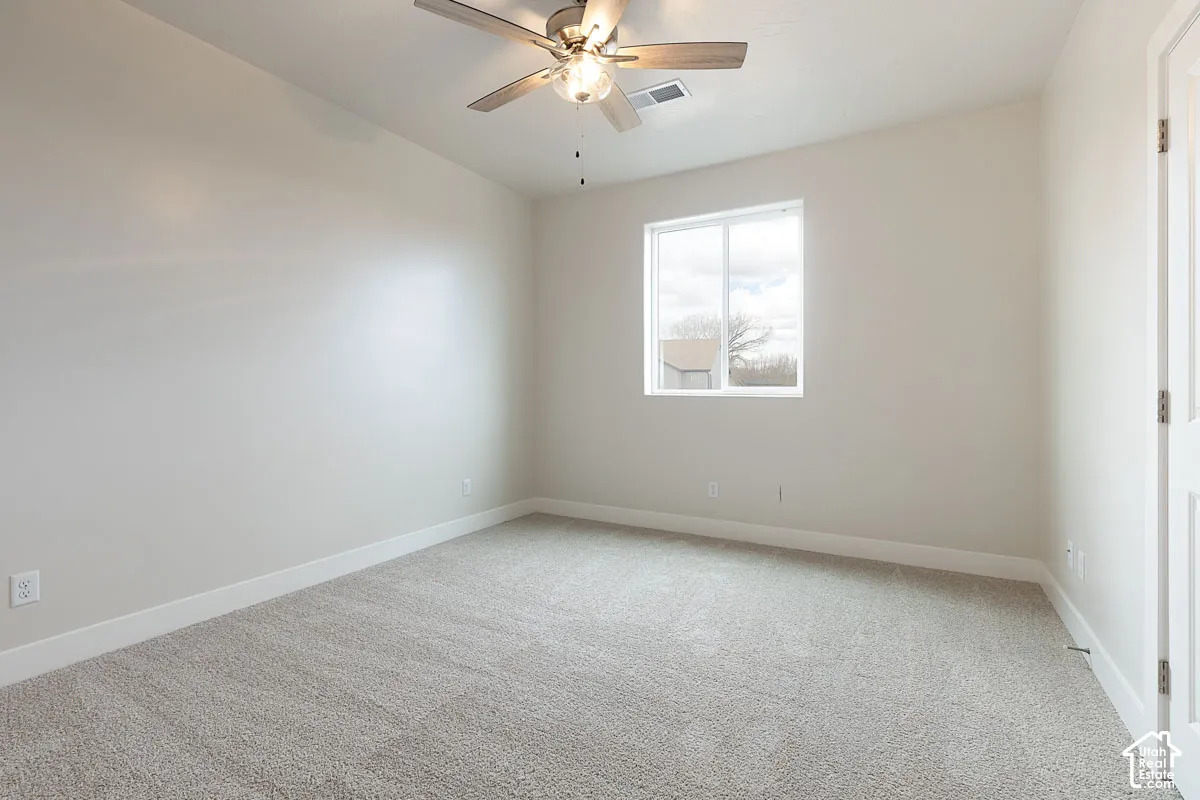 Unfurnished room with light carpet and ceiling fan