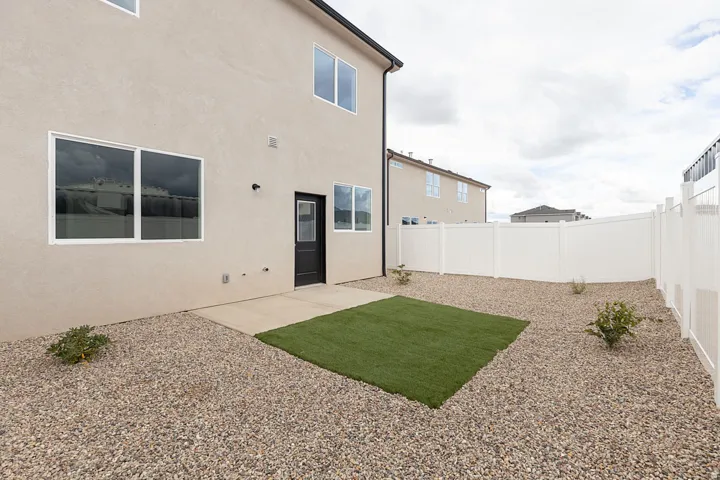 Rear view of property featuring a fenced backyard, stucco siding, and a patio area