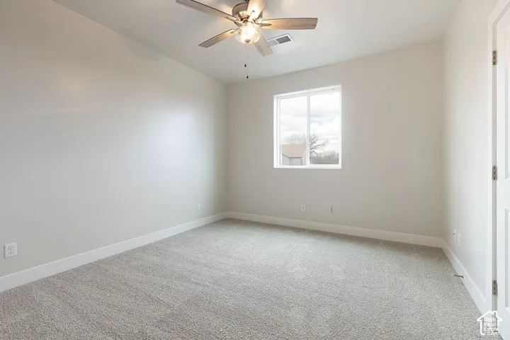 Unfurnished room with light carpet and ceiling fan
