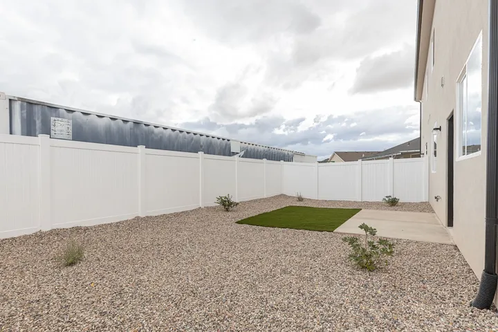 Fenced backyard with a patio area