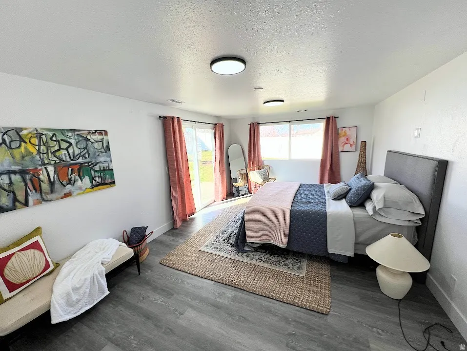 Bedroom featuring a textured ceiling and wood finished floors