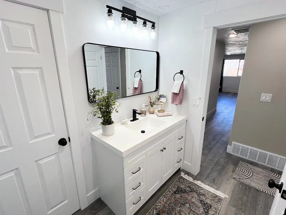 Bathroom featuring vanity and dark wood-style floors