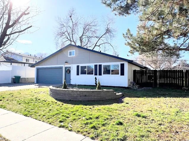 View of front facade featuring a garage and driveway