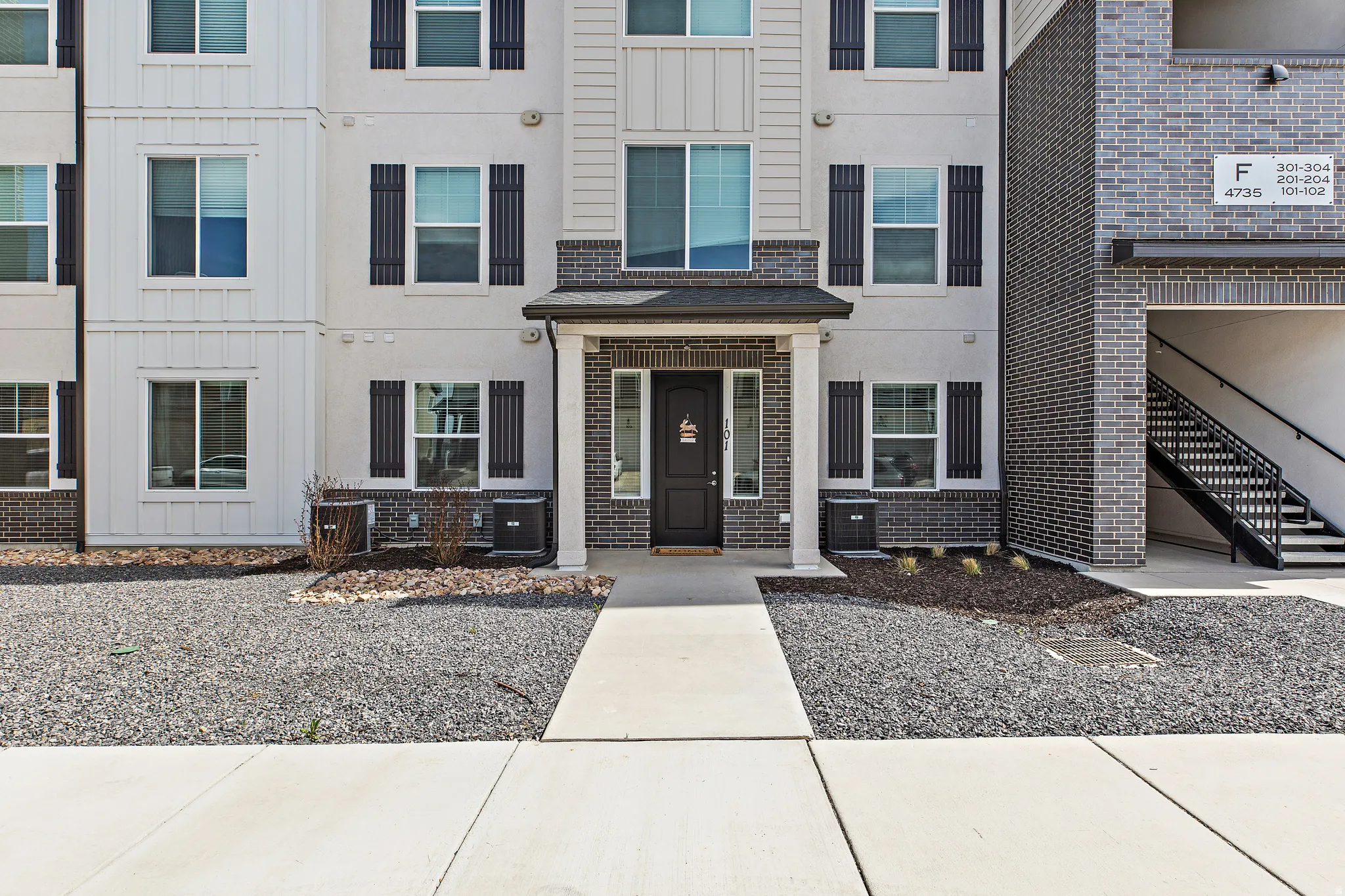 View of front of house featuring brick siding and board and batten siding