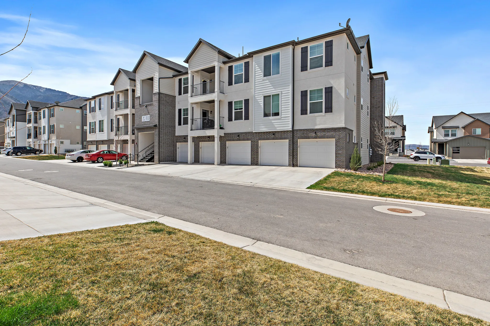 View of asphalt road with curbs and a mountain view