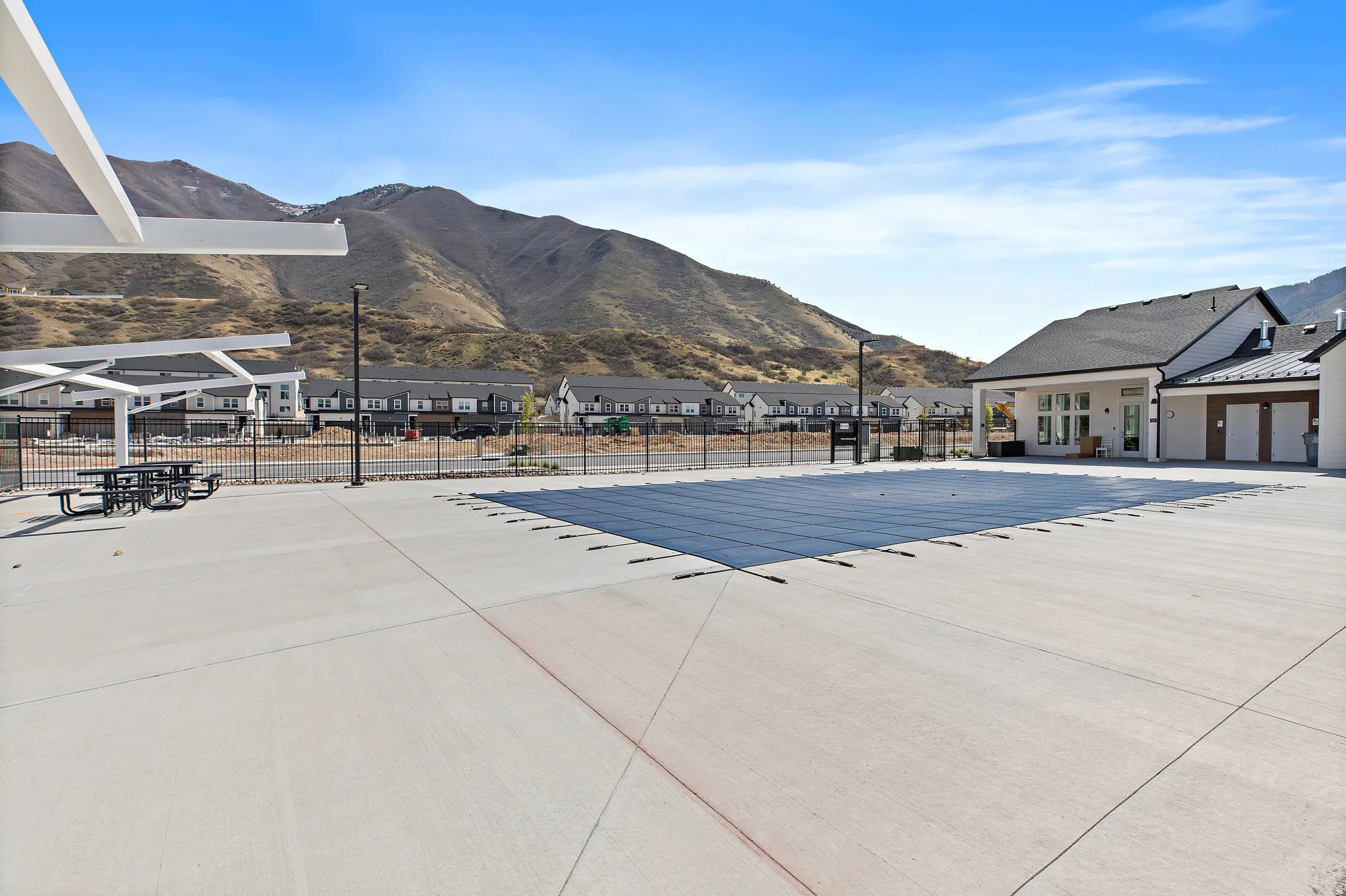 Community pool with a mountain view, a residential view, and a patio