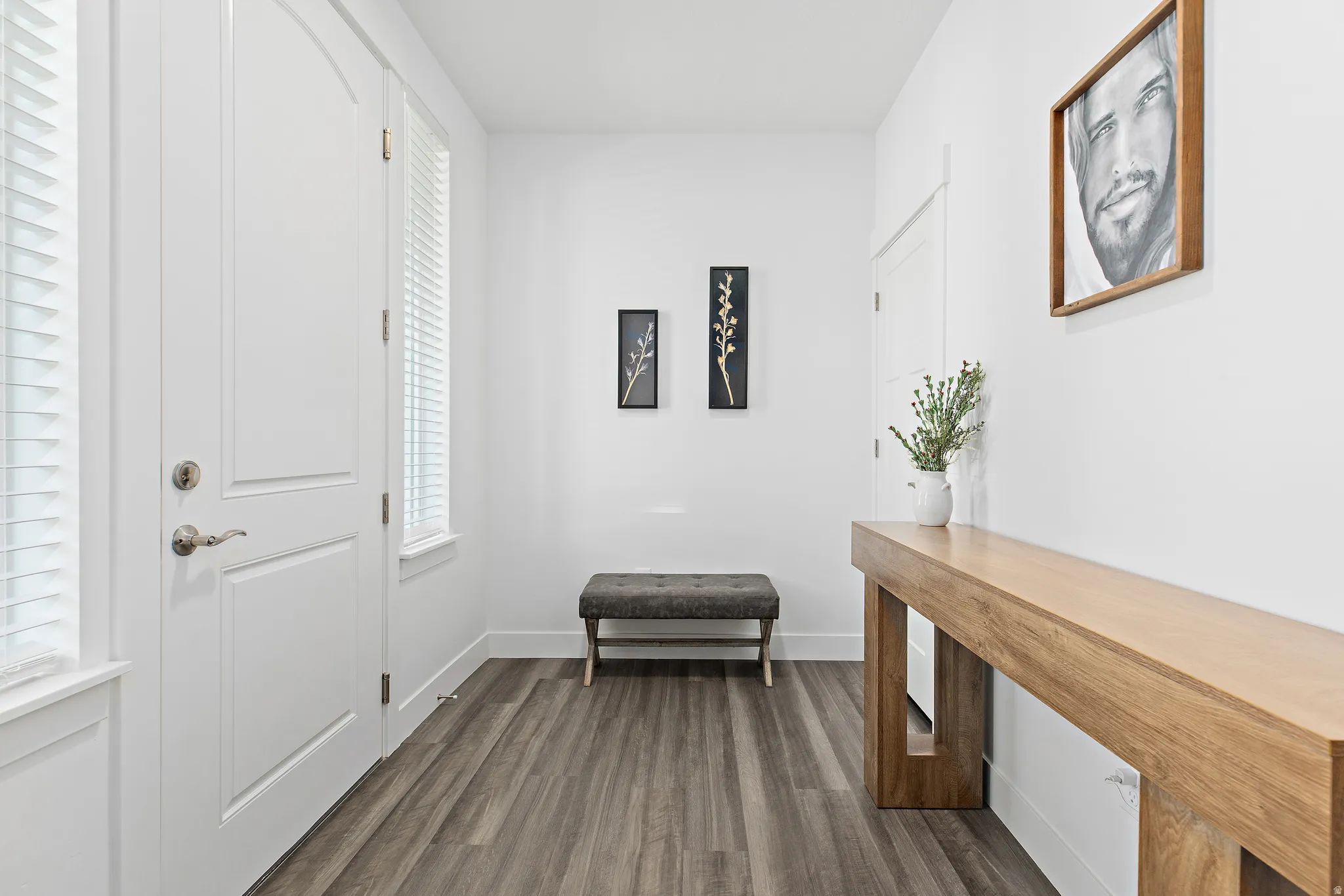 Entryway with dark wood-style flooring and baseboards