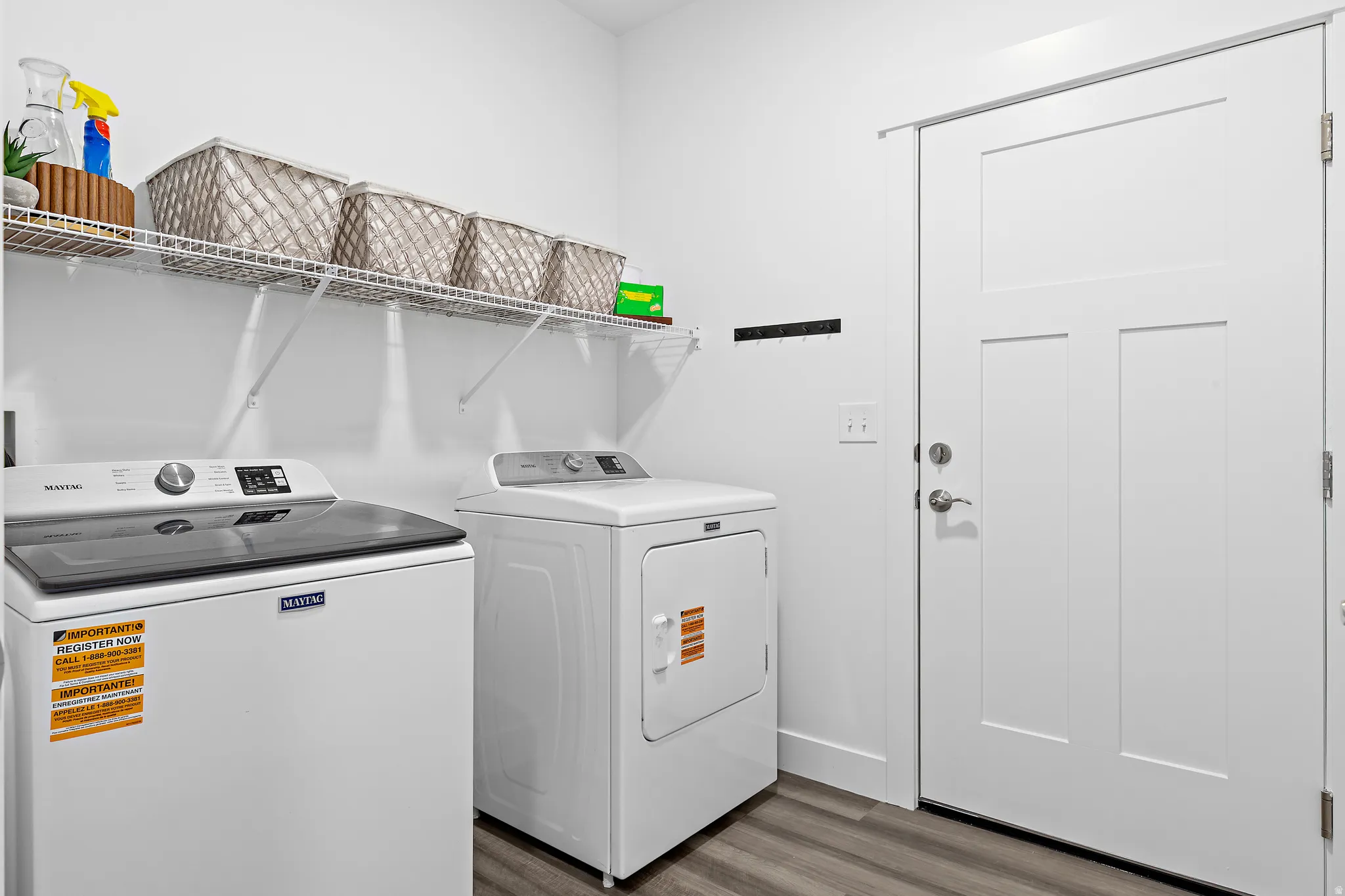 Laundry area with washer and dryer and dark wood-type flooring